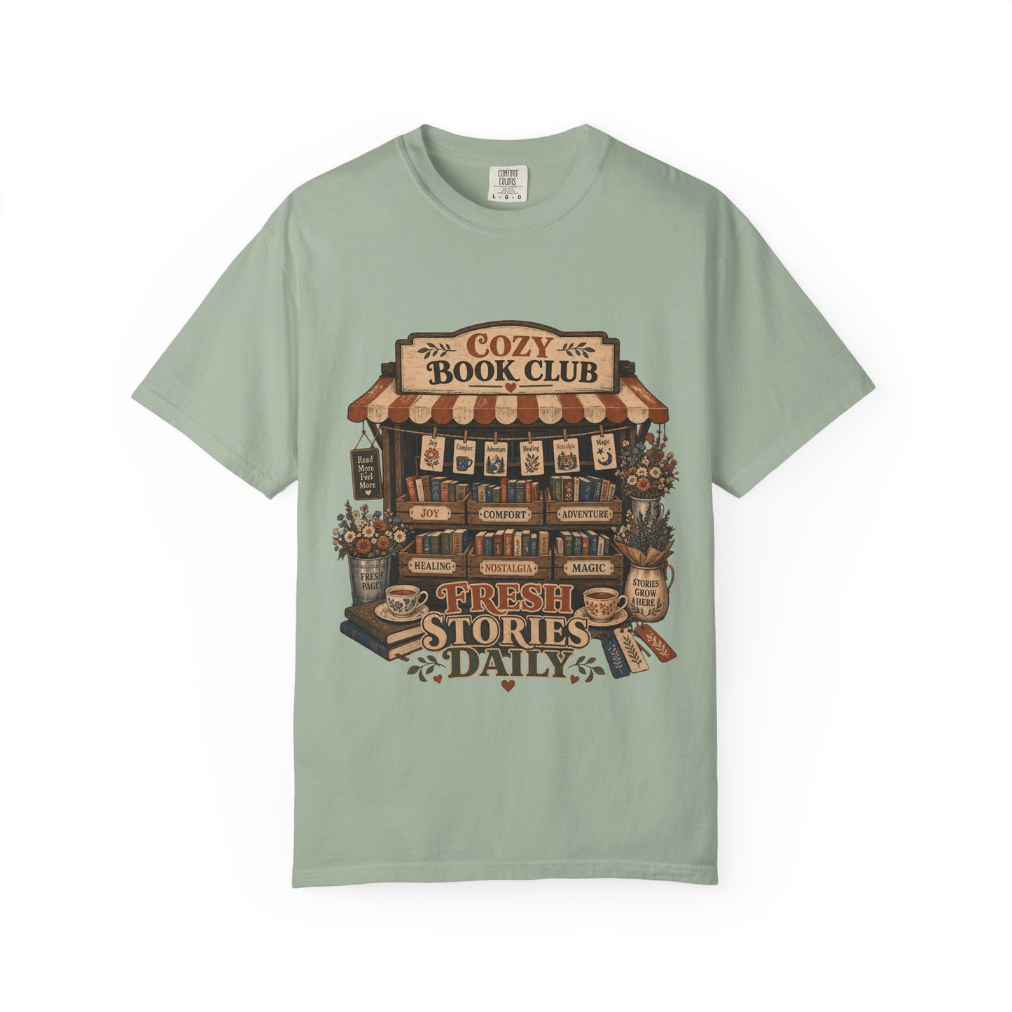 Front view of the Fresh Stories Daily Book Lover Shirt on a Comfort Colors 1717 garment-dyed T-shirt in Bay featuring a cosy book club bookshop design with books, flowers and tea.