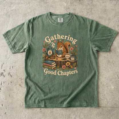 Gathering Good Chapters squirrel reading T-shirt in Moss featuring a squirrel with a book, teapot, teacup, acorns and flowers