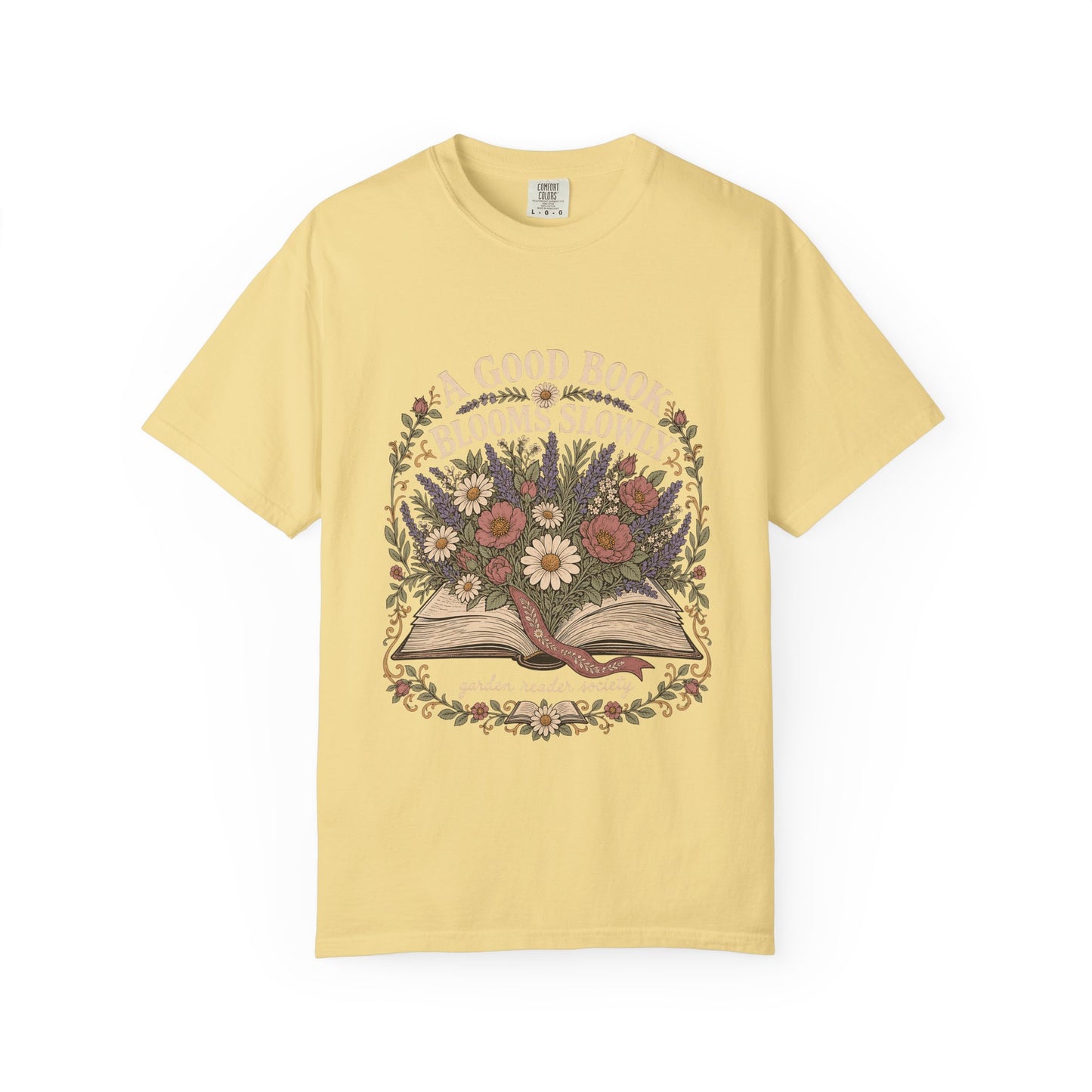A Good Book Blooms Slowly botanical reading T-shirt with an open book and flowers on Butter.