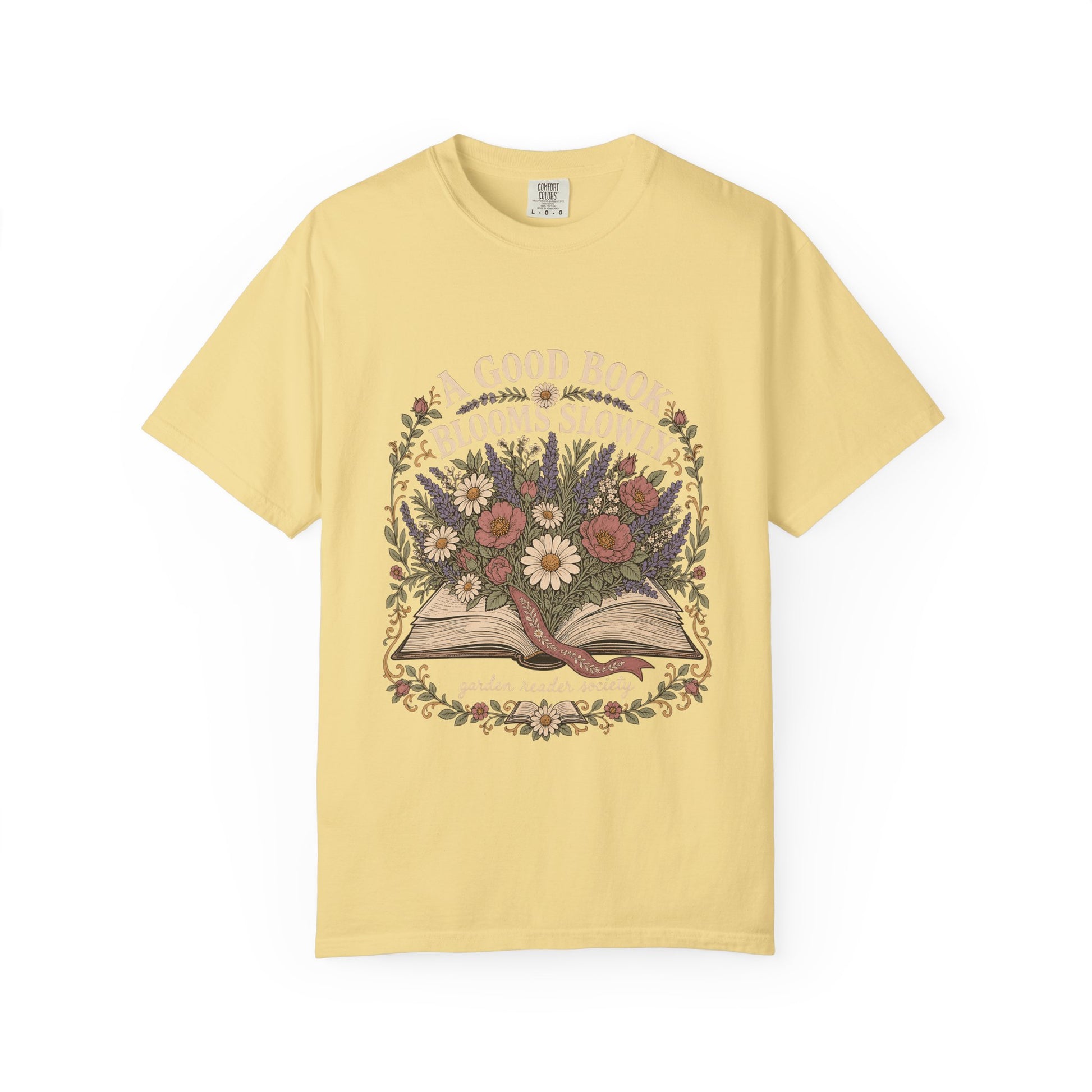 A Good Book Blooms Slowly botanical reading T-shirt with an open book and flowers on Butter.