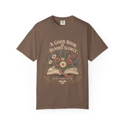 A Good Book Blooms Slowly botanical reading T-shirt with an open book and flowers on Espresso.