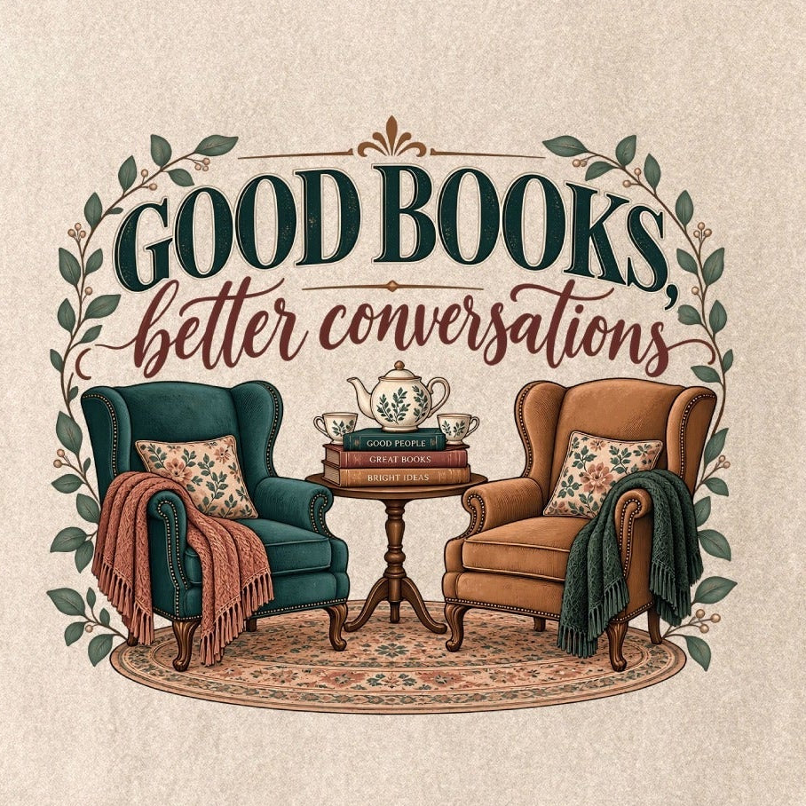 Close-up of the “Good Books, Better Conversations” T-shirt design, showing two armchairs around a tea table, stacked books, floral cushions and leafy framing.