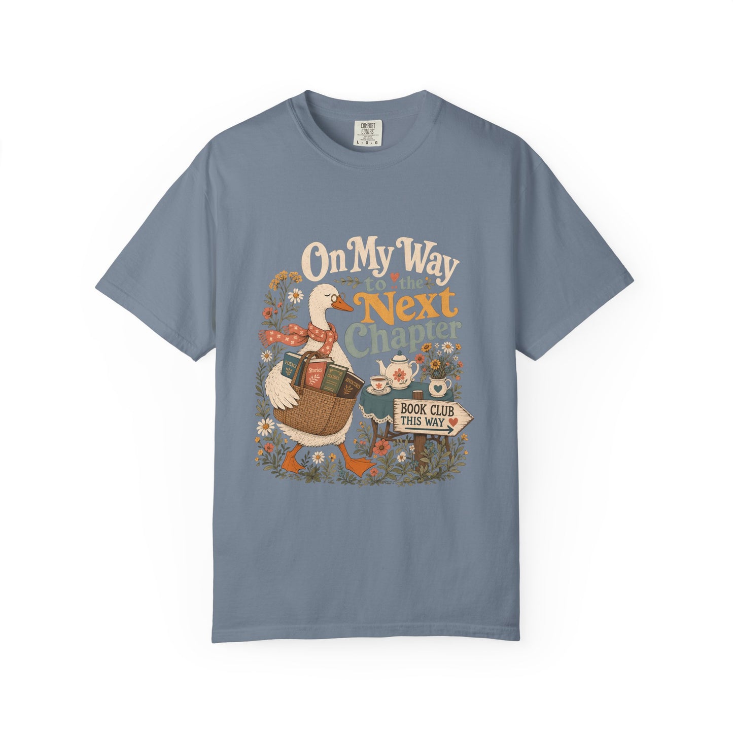 On My Way to the Next Chapter book club T-shirt with goose carrying a basket of books on Blue Jean.