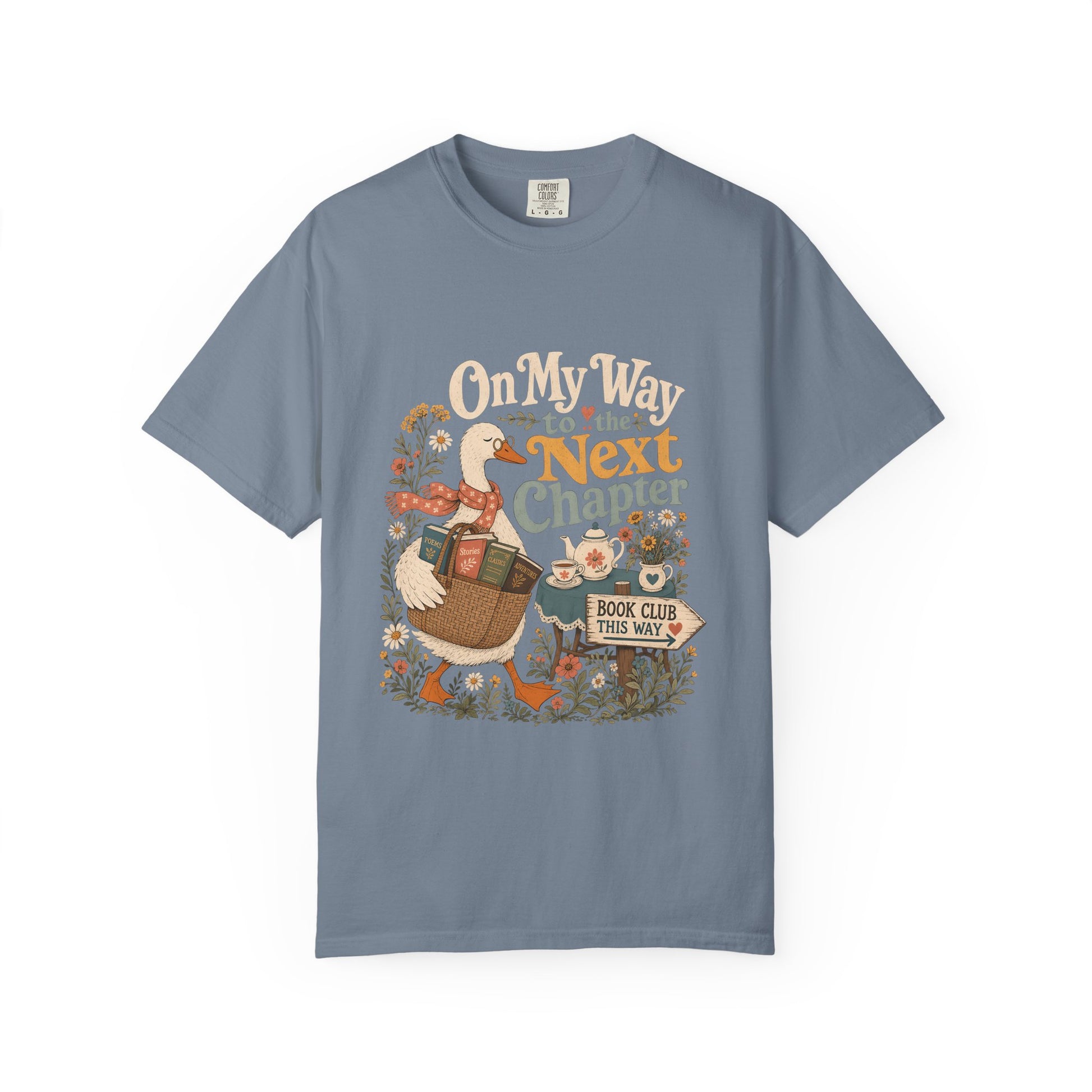 On My Way to the Next Chapter book club T-shirt with goose carrying a basket of books on Blue Jean.