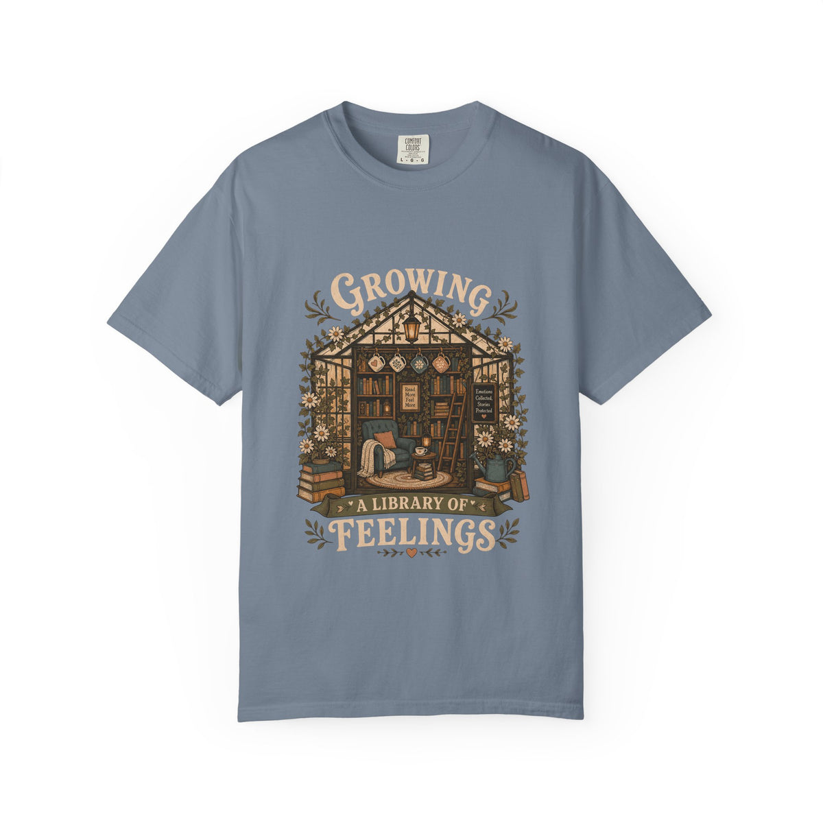 Growing a Library of Feelings book lover T-shirt in Blue Jean featuring a botanical greenhouse library with books and a reading chair
