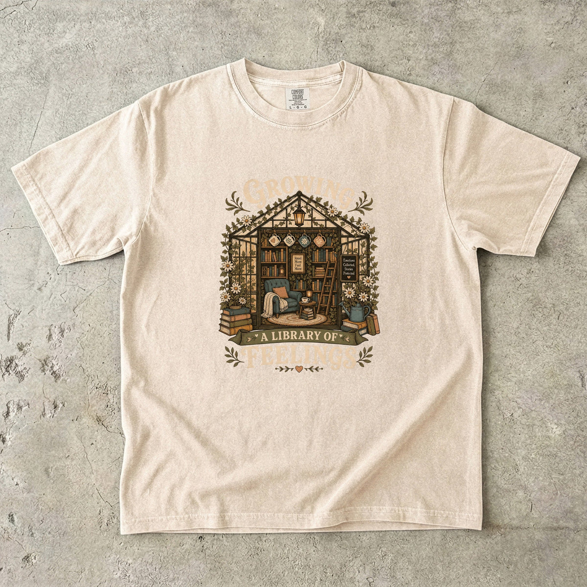 Growing a Library of Feelings book lover T-shirt in Ivory featuring a botanical greenhouse library with books and a reading chair
