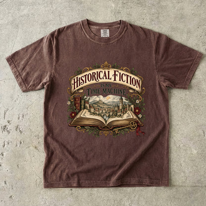 Espresso T-shirt featuring “Historical Fiction Is My Time Machine” with an open book revealing an old-world town, ornate gold framing, antique books, leaves and burgundy flowers.