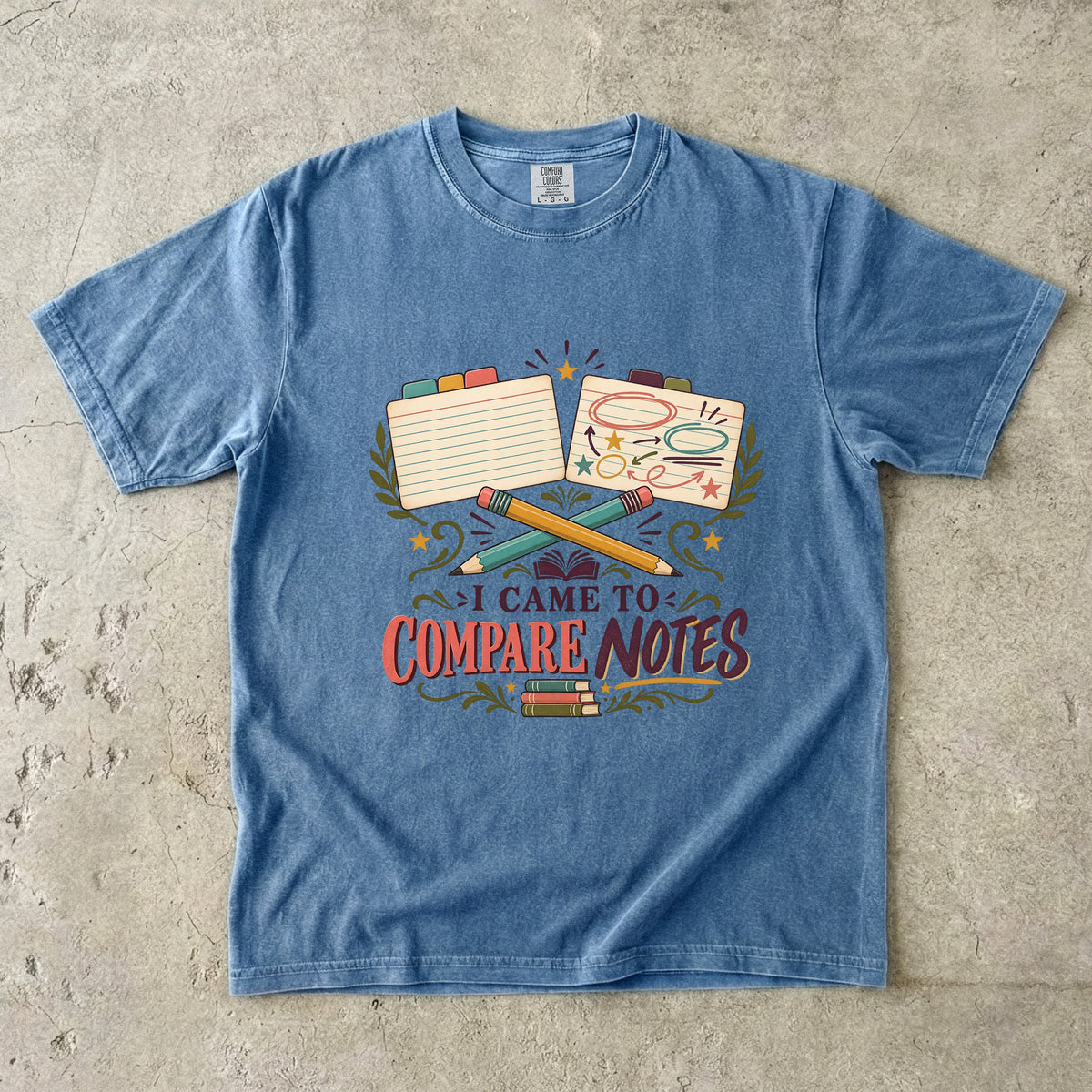Blue Jean book club T-shirt with “I Came to Compare Notes,” tabbed note cards and crossed pencils