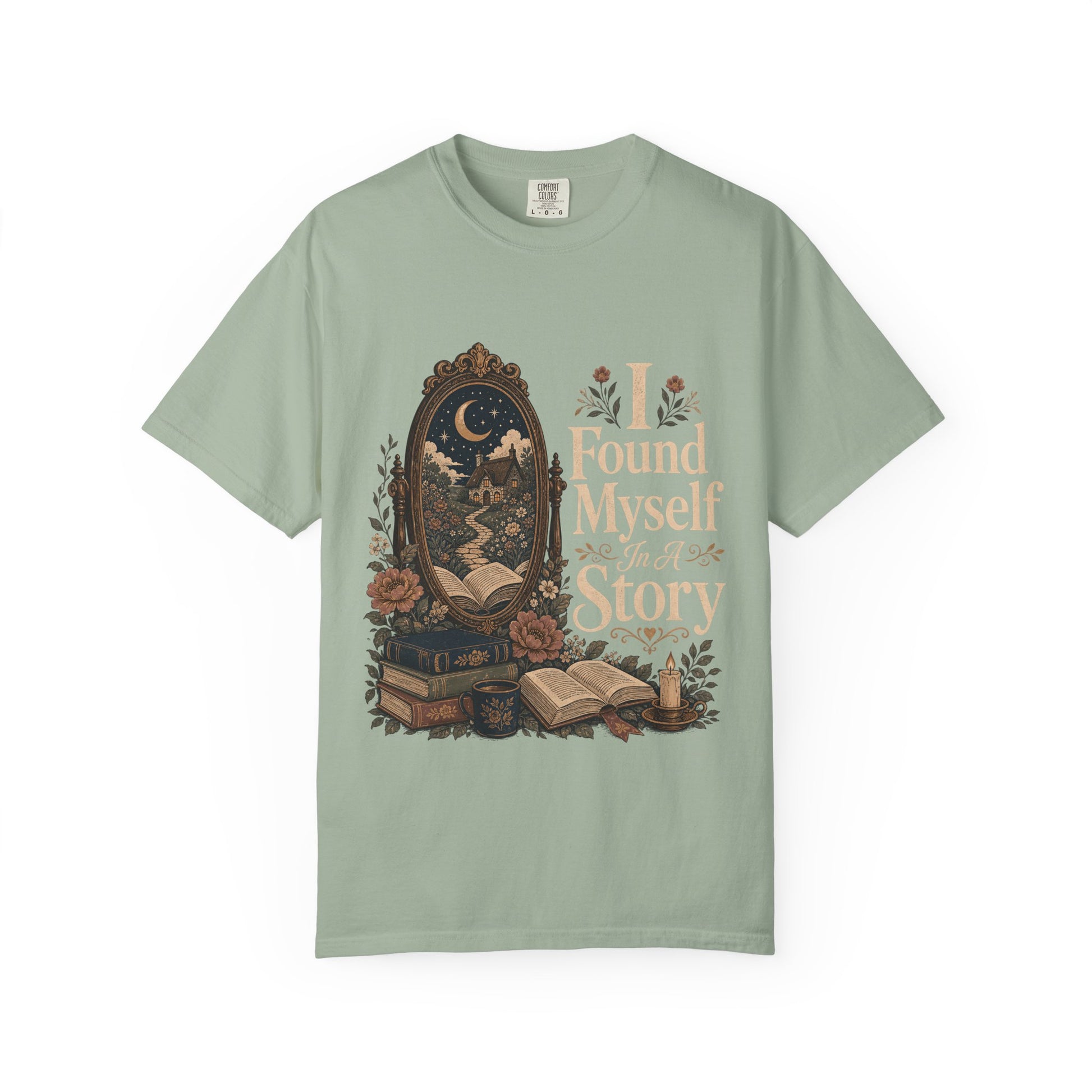 Front view of the I Found Myself In A Story Book Lover Shirt on a Comfort Colors 1717 garment-dyed T-shirt in Bay featuring an antique mirror, books and cottagecore-inspired literary artwork.