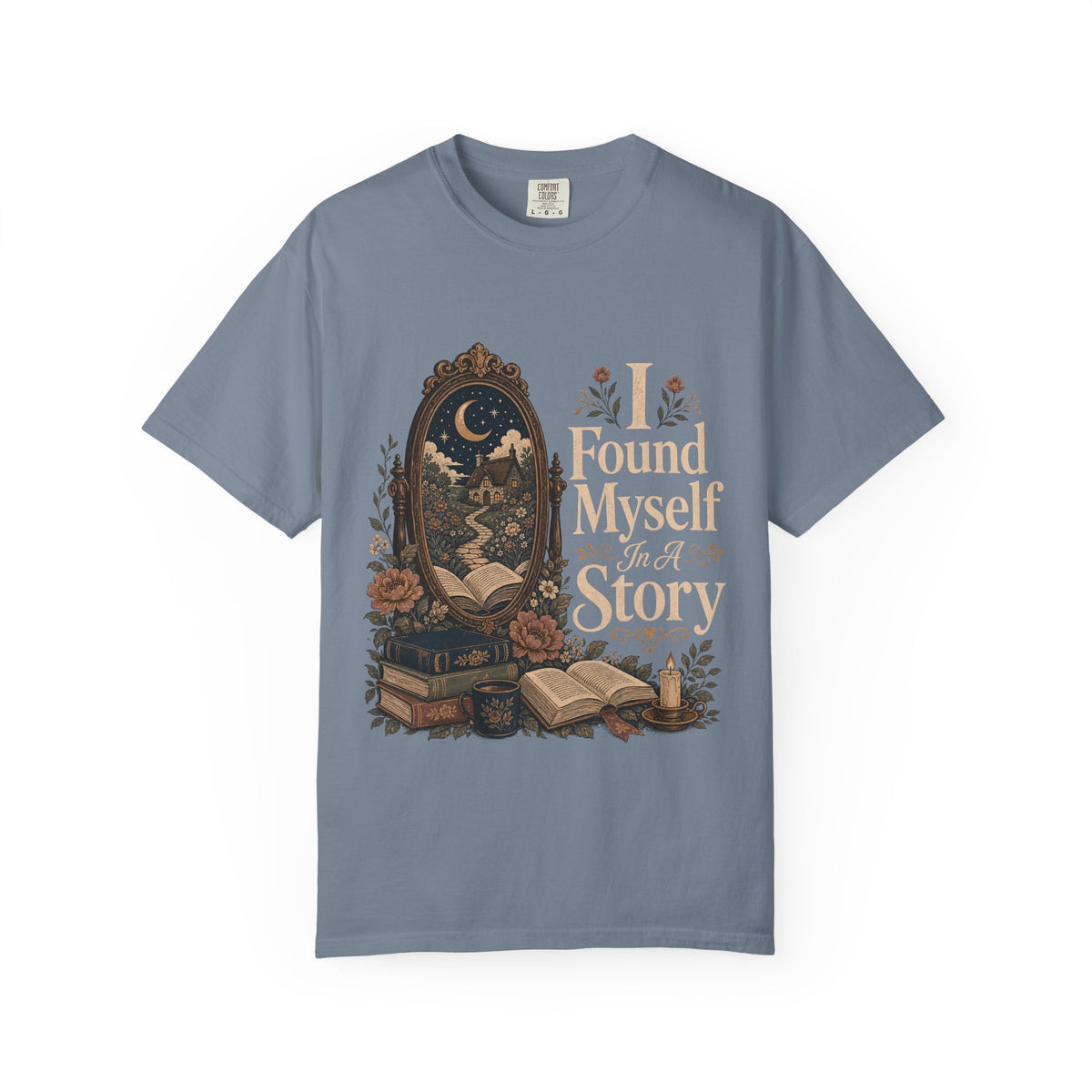 I Found Myself in a Story book lover T-shirt in Blue Jean featuring a moonlit cottage, ornate mirror, open books and flowers