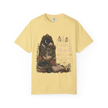 I Found Myself in a Story book lover T-shirt in Butter featuring a moonlit cottage, ornate mirror, open books and flowers