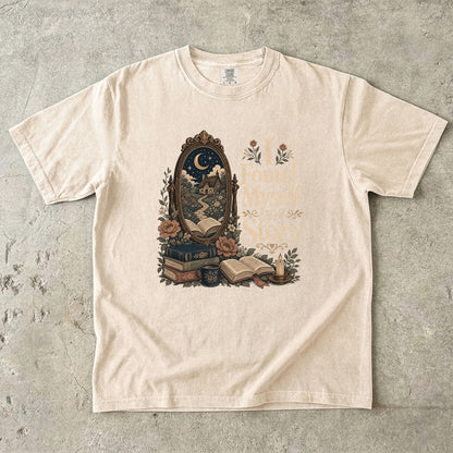I Found Myself in a Story book lover T-shirt in Ivory featuring a moonlit cottage, ornate mirror, open books and flowers