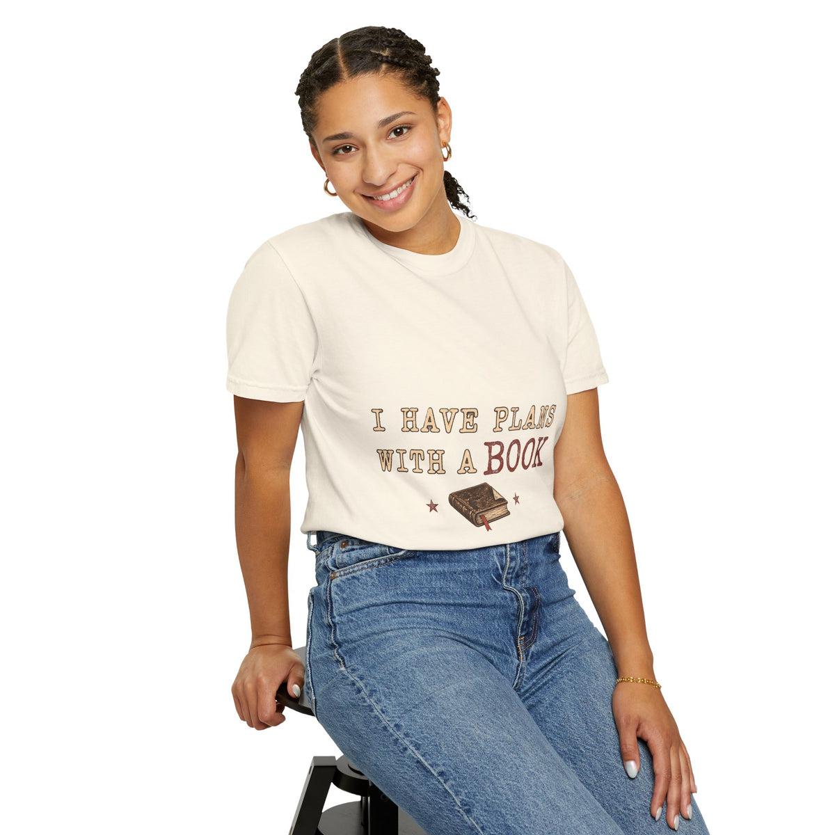 T-shirt featuring “I Have Plans With a Book” in a lifestyle presentation.