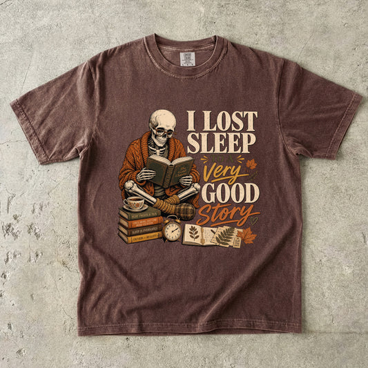 Espresso Comfort Colors T-shirt featuring a vintage skeleton reader and I Lost Sleep to a Very Good Story artwork.