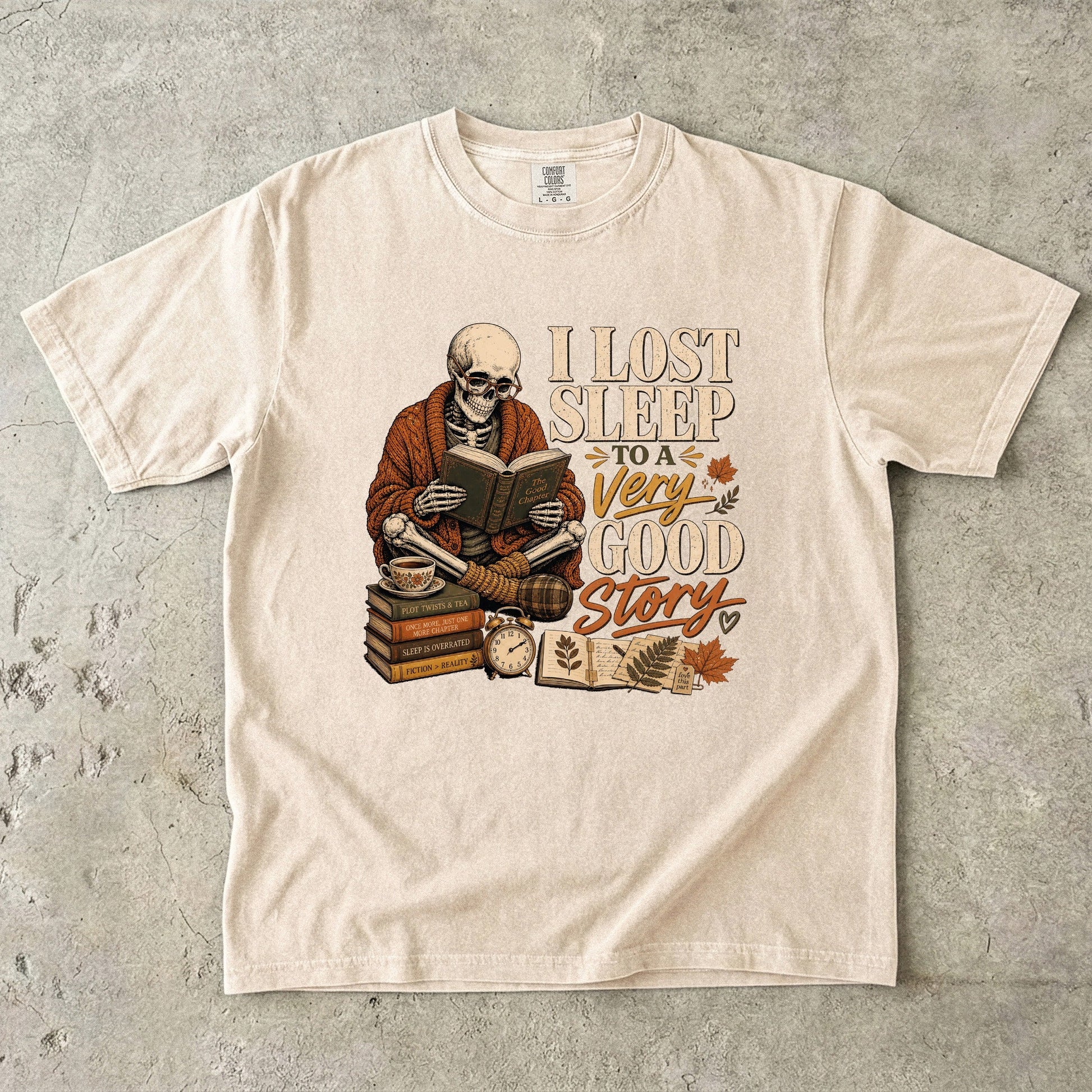 Ivory Comfort Colors book lover T-shirt with a vintage skeleton reader and I Lost Sleep to a Very Good Story design.