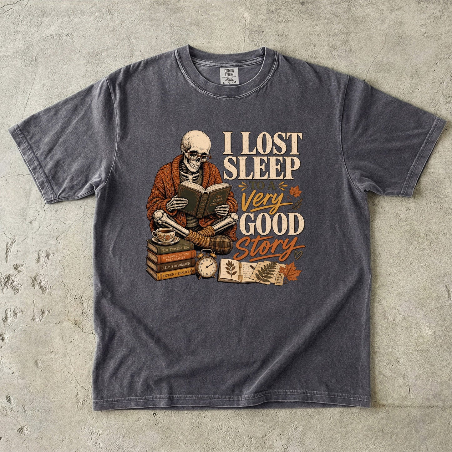 Pepper Comfort Colors book lover T-shirt featuring a skeleton reading and I Lost Sleep to a Very Good Story design.