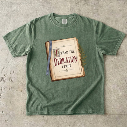 Moss reader T-shirt with “I Read the Dedication First” inside an illustrated old book