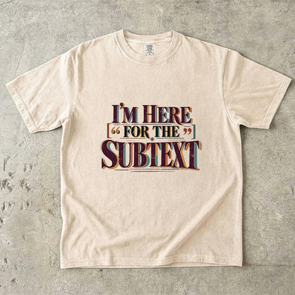Ivory literary T-shirt with “I’m Here for the Subtext” in bold layered vintage lettering