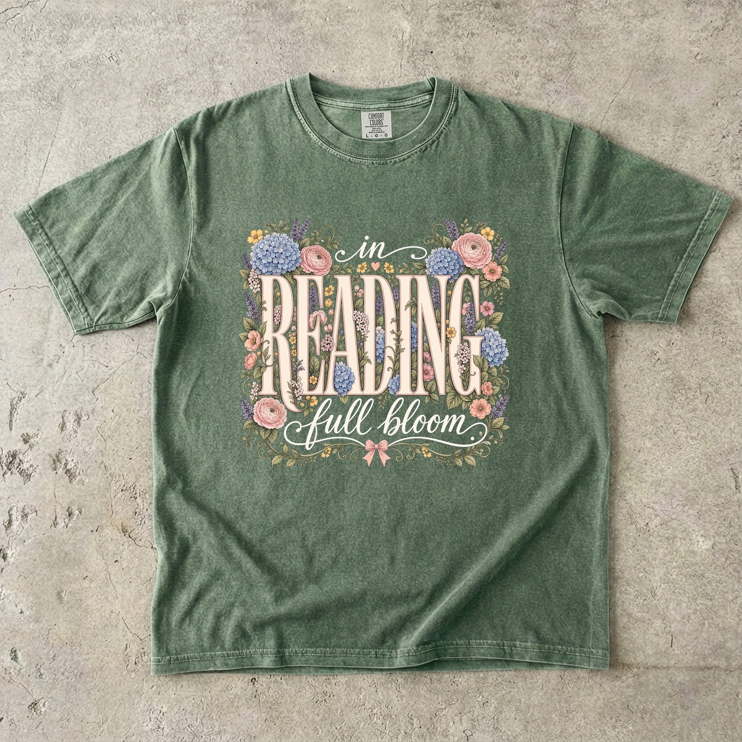 Moss Comfort Colors book lover T-shirt featuring the In Reading, Full Bloom floral reading design with roses, hydrangeas and botanical details.