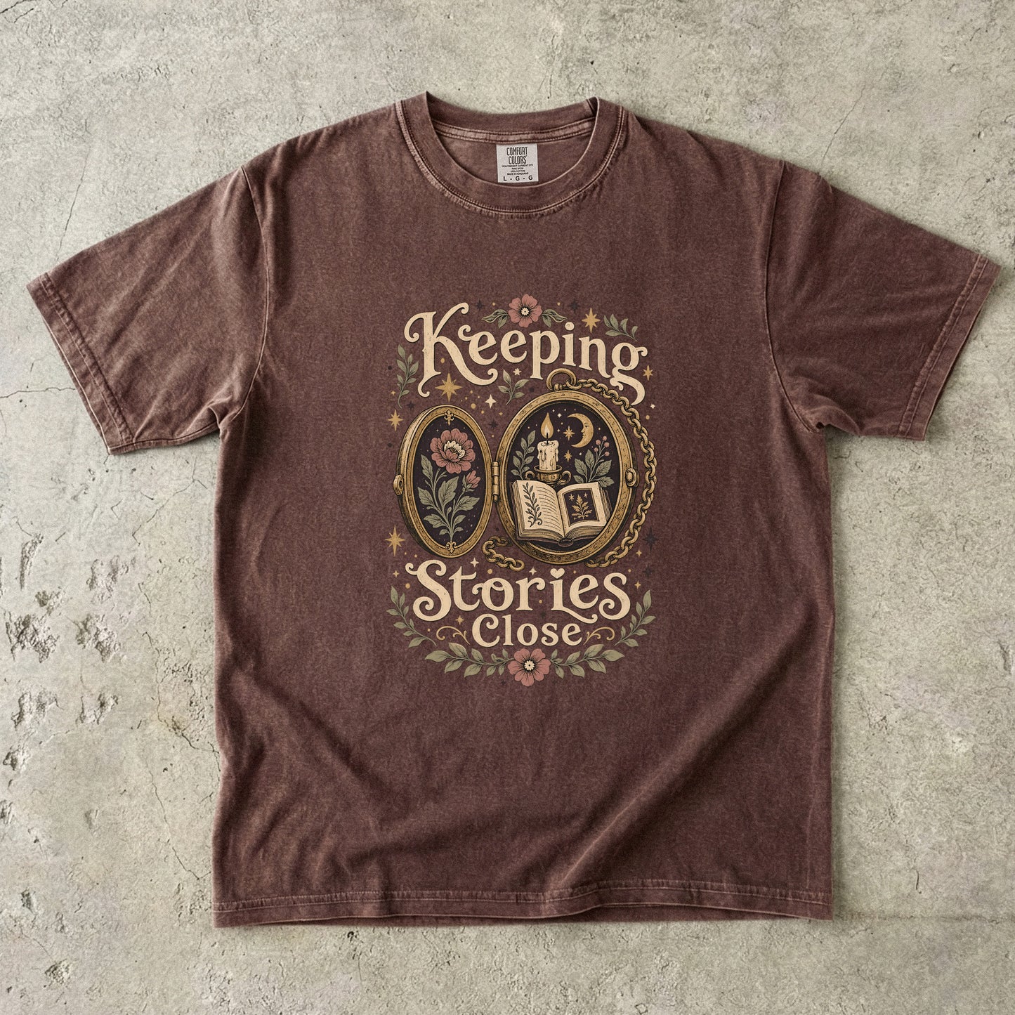 Front view of an Espresso Comfort Colors Book Lover T-shirt featuring the Keeping Stories Close design