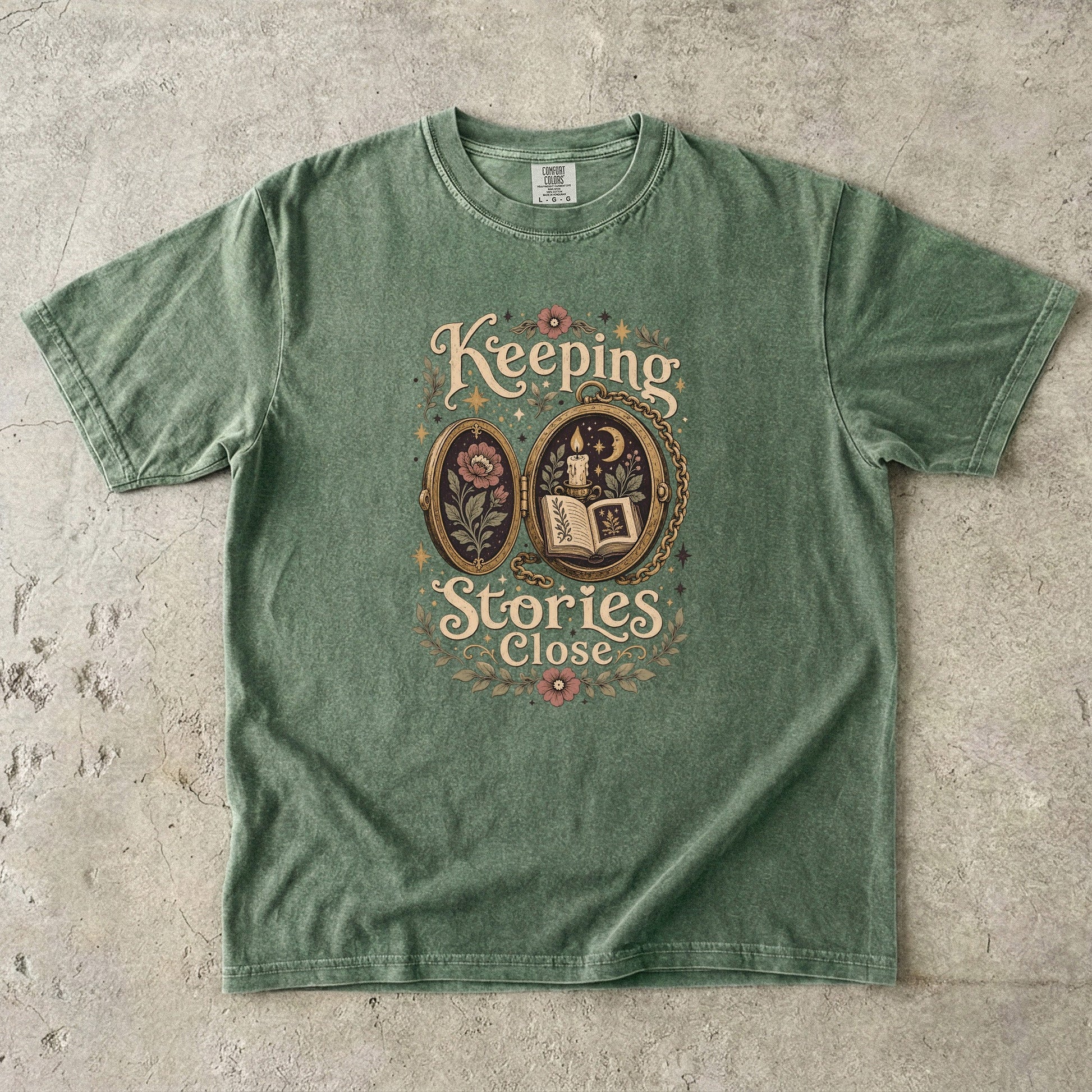 Front view of a Moss Comfort Colors Book Lover T-shirt featuring the vintage storybook locket artwork.