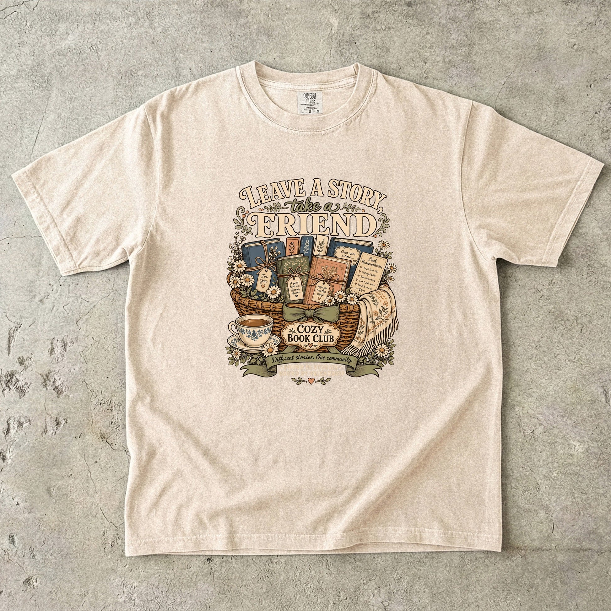 Leave a Story, Take a Friend book club T-shirt with gift basket of books and flowers on Ivory.