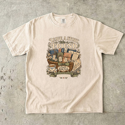 Leave a Story, Take a Friend book club T-shirt with gift basket of books and flowers on Ivory.