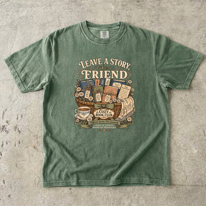 Leave a Story, Take a Friend book club T-shirt with gift basket of books and flowers on Moss.