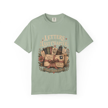 Front view of the Letters From the Last Chapter book club illustration printed on a Bay Comfort Colors T-shirt