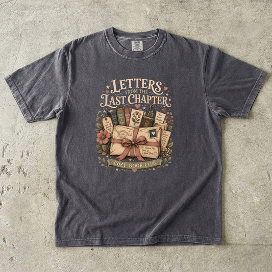 Front view of the Letters From the Last Chapter book club illustration printed on a Pepper Comfort Colors T-shirt. 