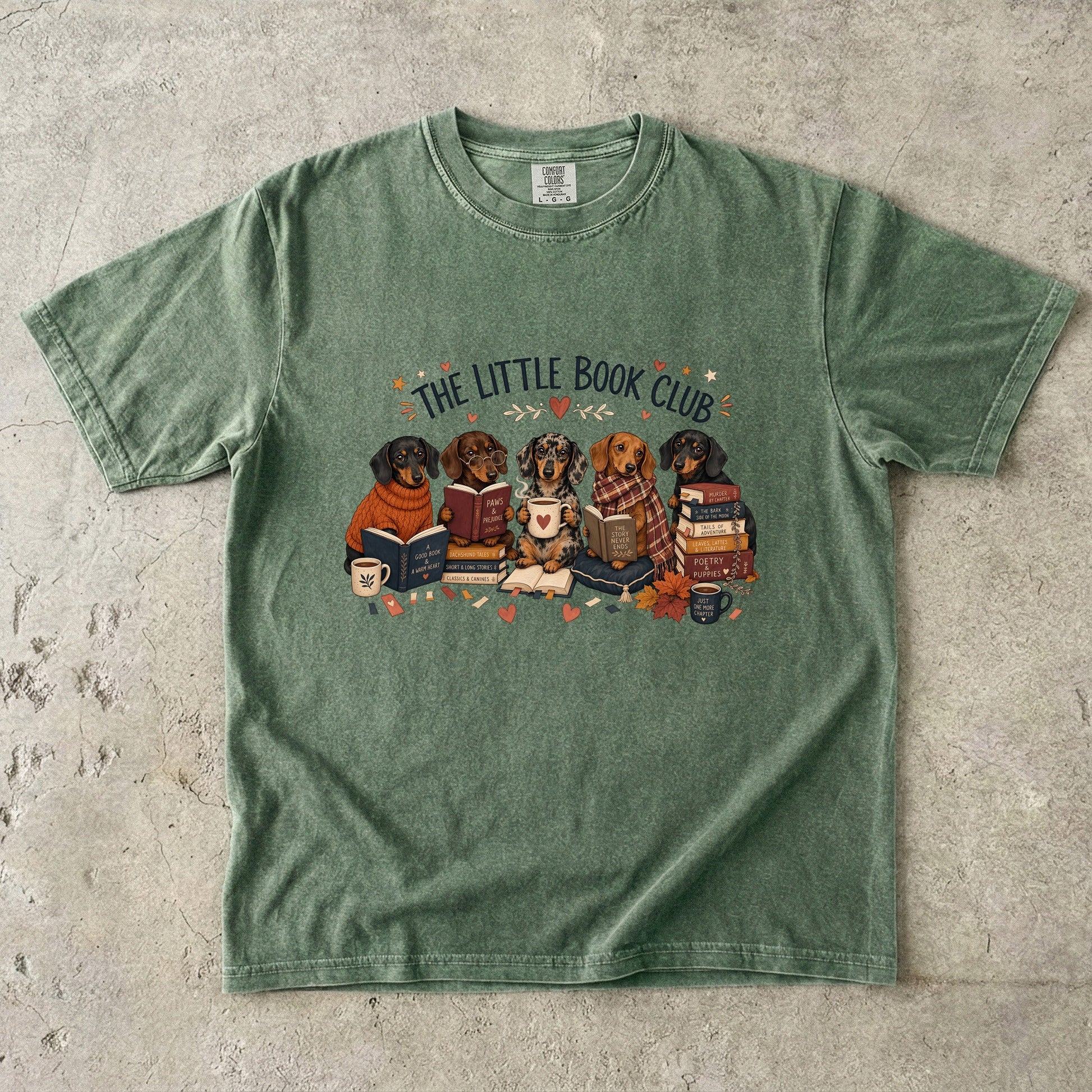 Moss Comfort Colors dog lover book shirt featuring dachshunds reading among stacked books, mugs and autumn details.