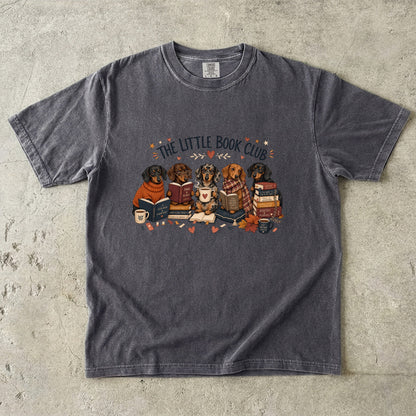 Pepper Comfort Colors book lover T-shirt featuring The Little Book Club dachshund reading illustration.