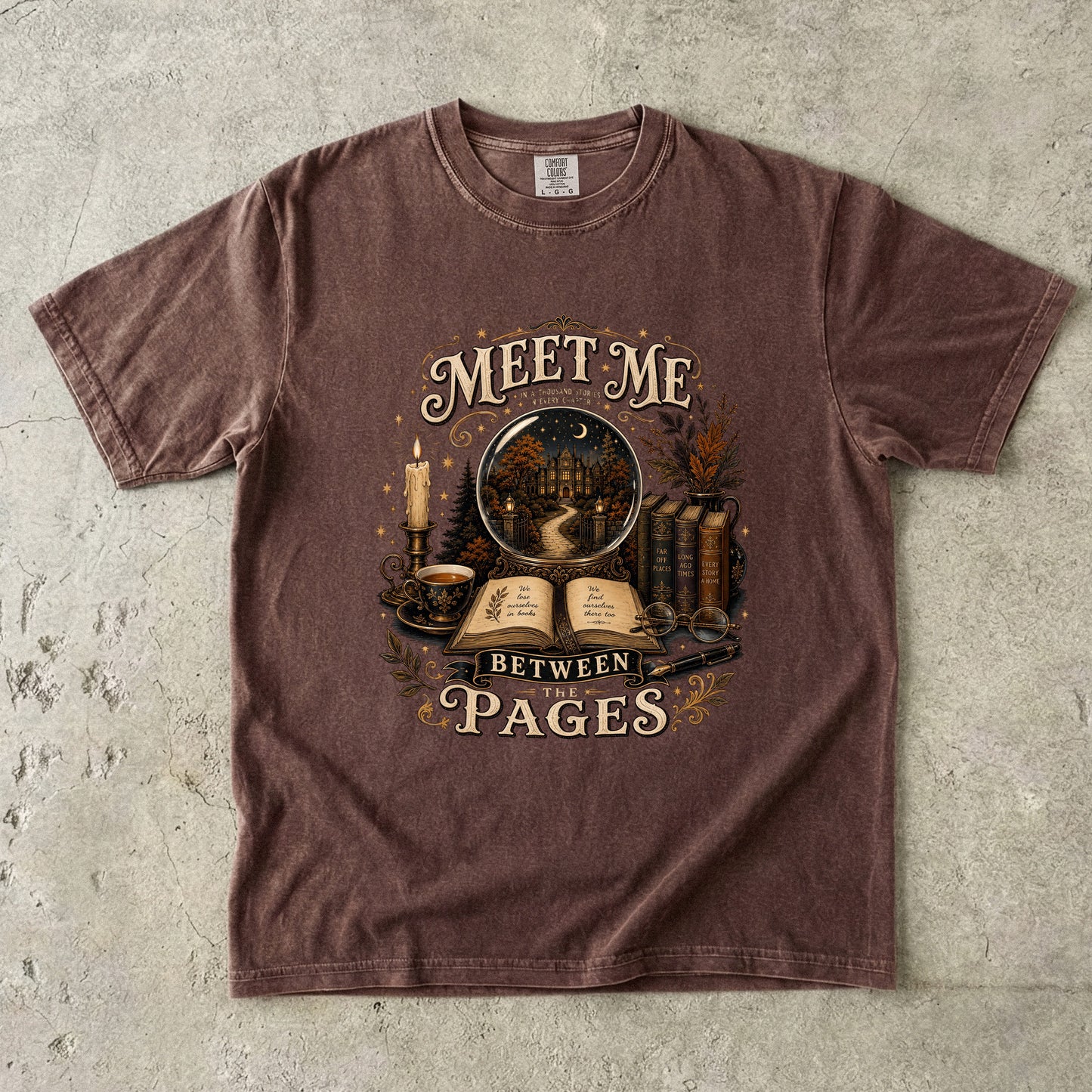 Meet Me Between the Pages book lover Comfort Colors T-shirt in Espresso with vintage books, candle and fictional world illustration.