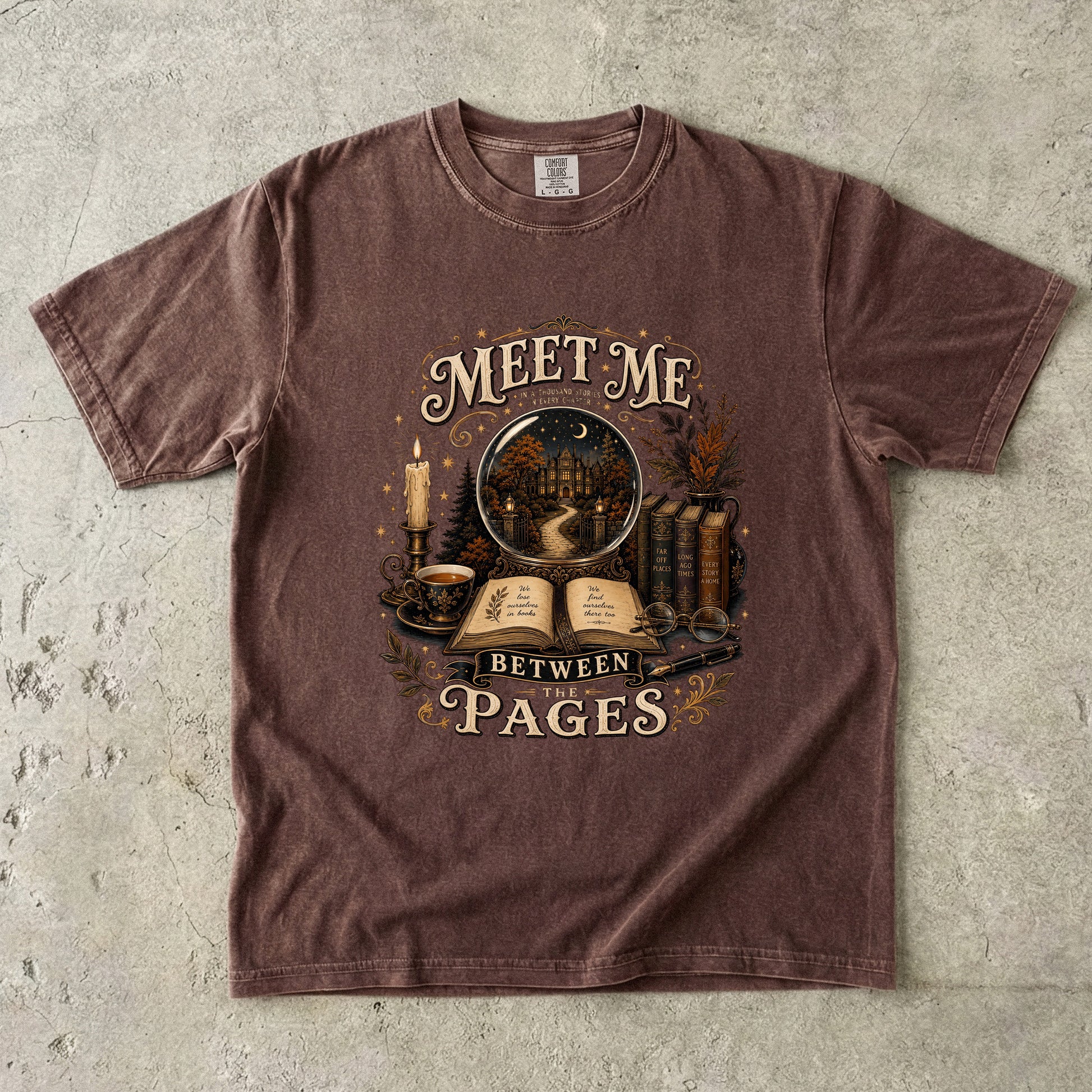 Meet Me Between the Pages book lover Comfort Colors T-shirt in Espresso with vintage books, candle and fictional world illustration.