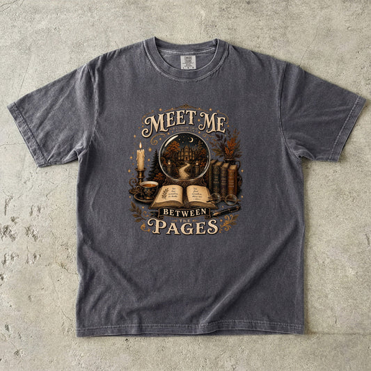 Pepper Comfort Colors book lover T-shirt featuring the Meet Me Between the Pages vintage reading design.