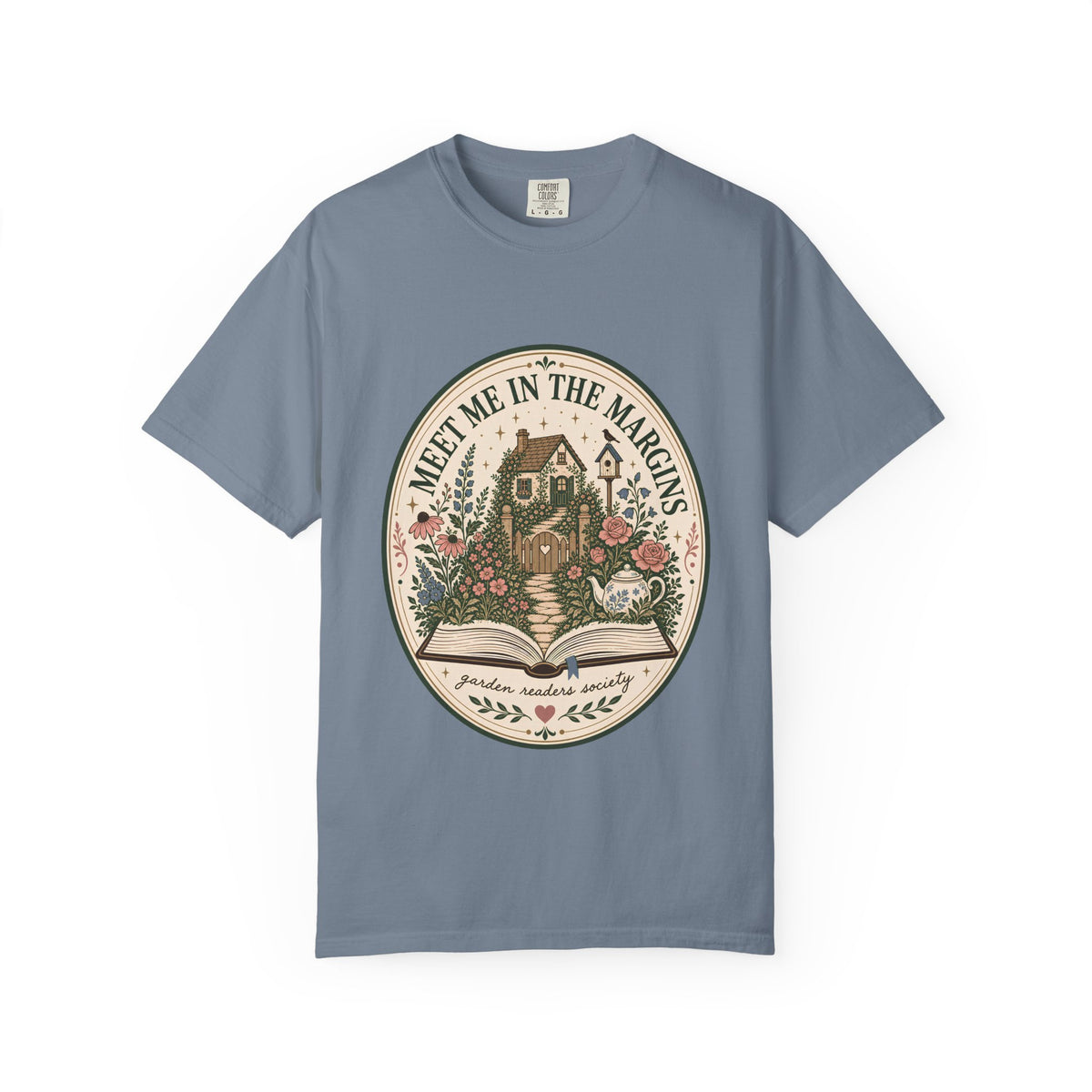 Meet Me in the Margins garden reader T-shirt featuring a cottage garden, flowers, teapot and open book design on Blue Jean.