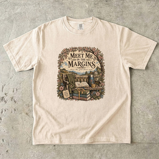 Meet Me in the Margins reading T-shirt featuring books, tea and a flower-framed countryside reading bench on Ivory.