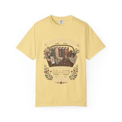Mending Hearts With Stories book club T-shirt in Butter featuring classic books, sewing notions, flowers and a woven basket