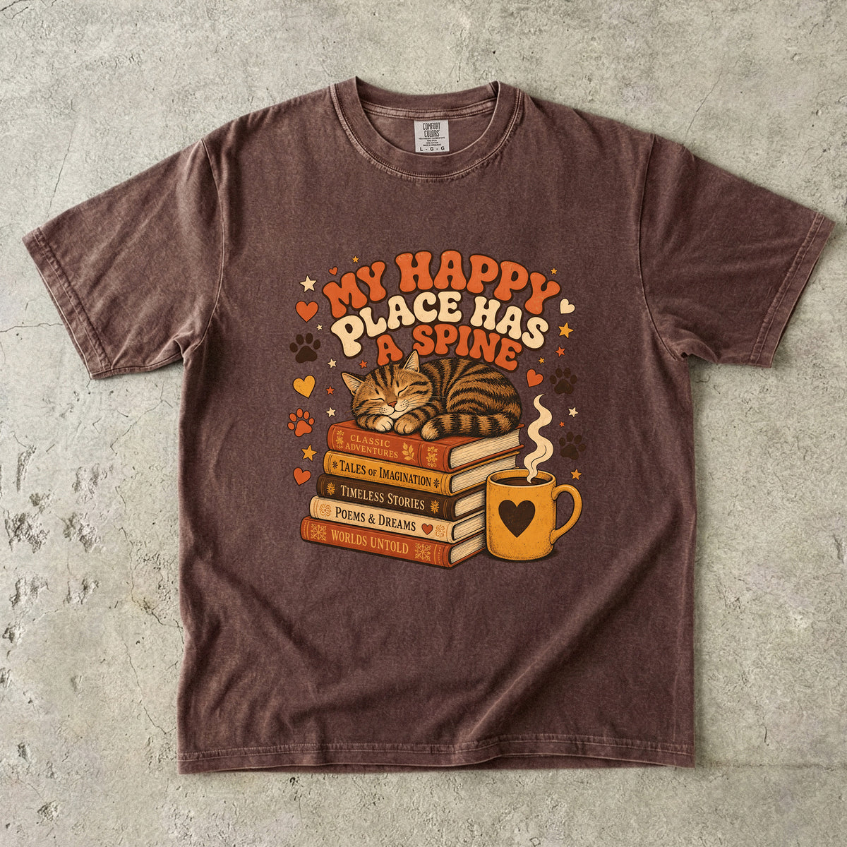 Espresso cat book lover T-shirt featuring a sleeping tabby on stacked books beside a steaming mug with hearts, stars and paw prints.