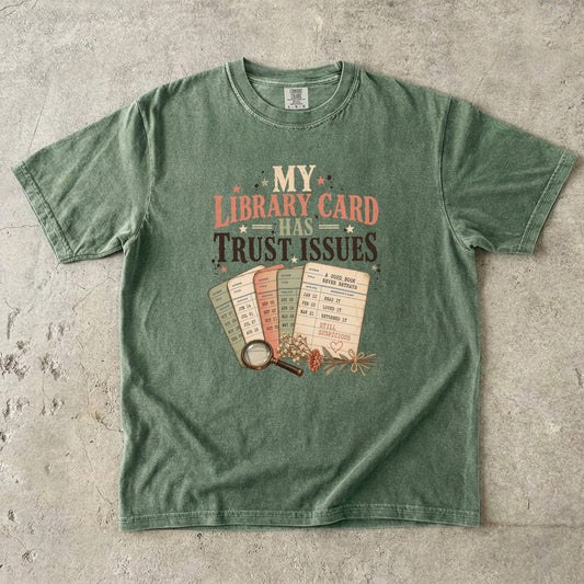 Moss library lover T-shirt featuring My Library Card Has Trust Issues with vintage library checkout cards, flowers and a magnifying glass.