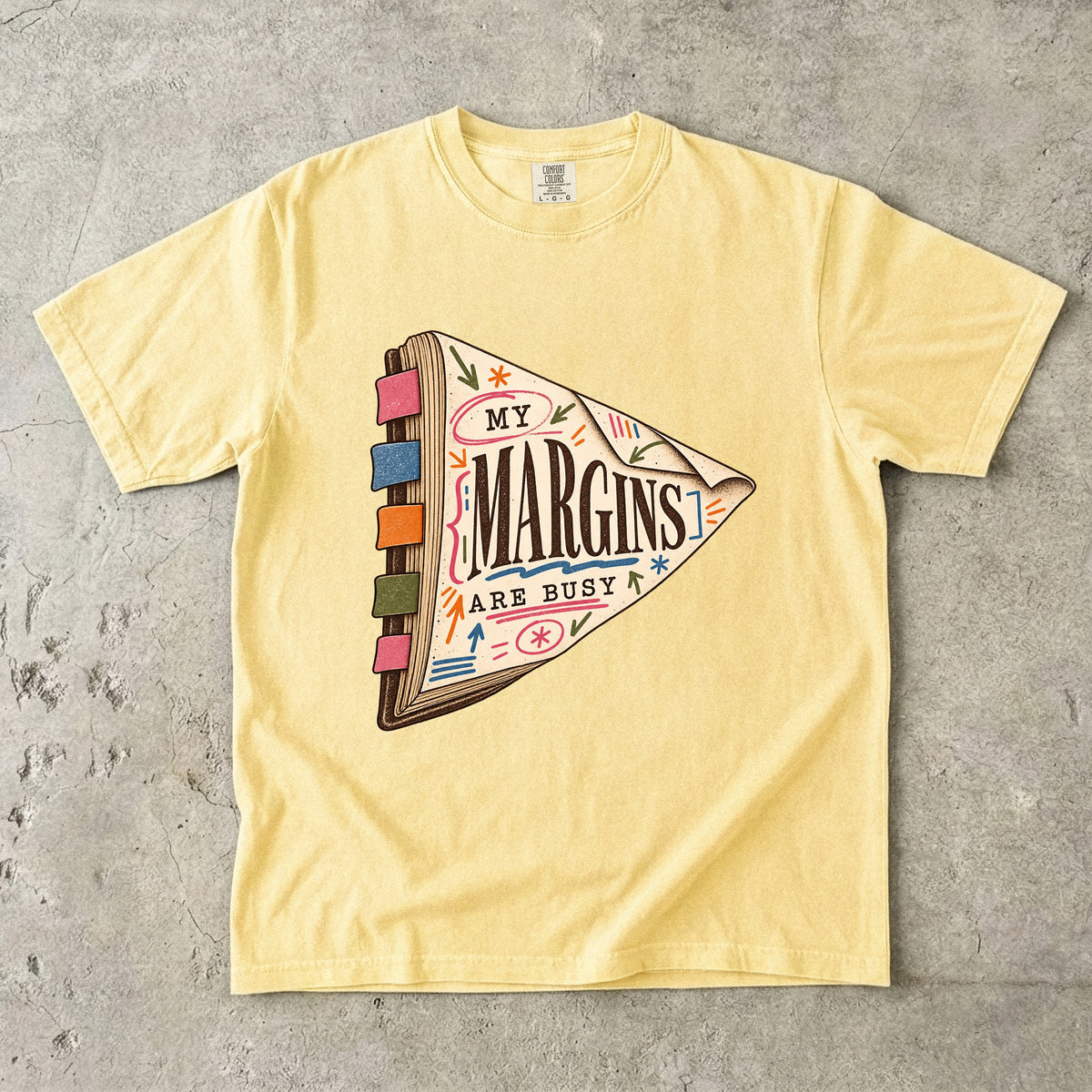 Butter reading T-shirt with “My Margins Are Busy” on a tabbed book with colourful annotations