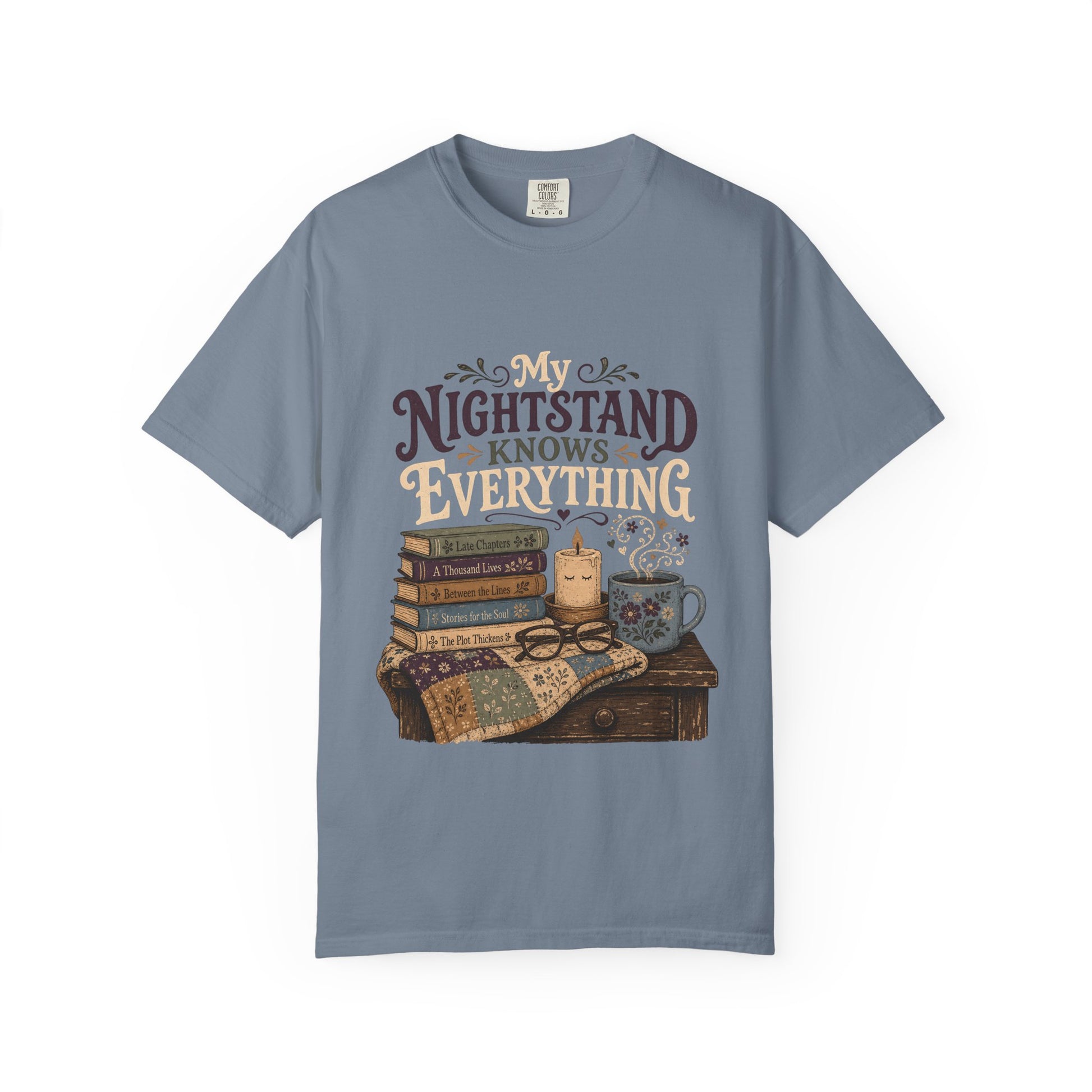 My Nightstand Knows Everything reading T-shirt in Blue Jean with stacked books, reading glasses, a candle and floral mug