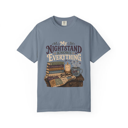 My Nightstand Knows Everything reading T-shirt in Blue Jean with stacked books, reading glasses, a candle and floral mug