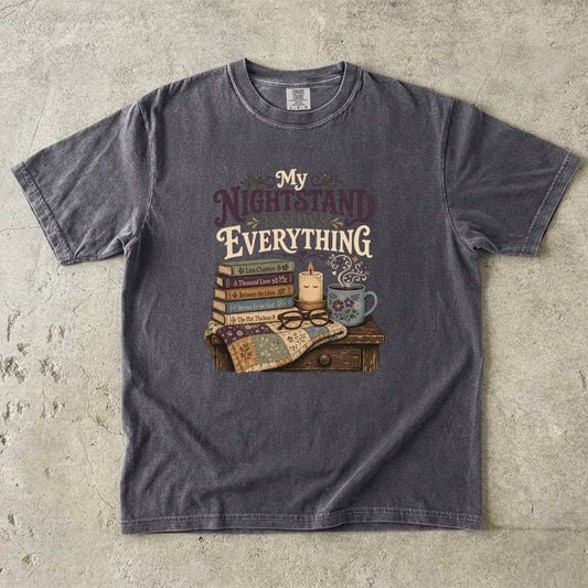 My Nightstand Knows Everything reading T-shirt in Pepper with stacked books, reading glasses, a candle and floral mug