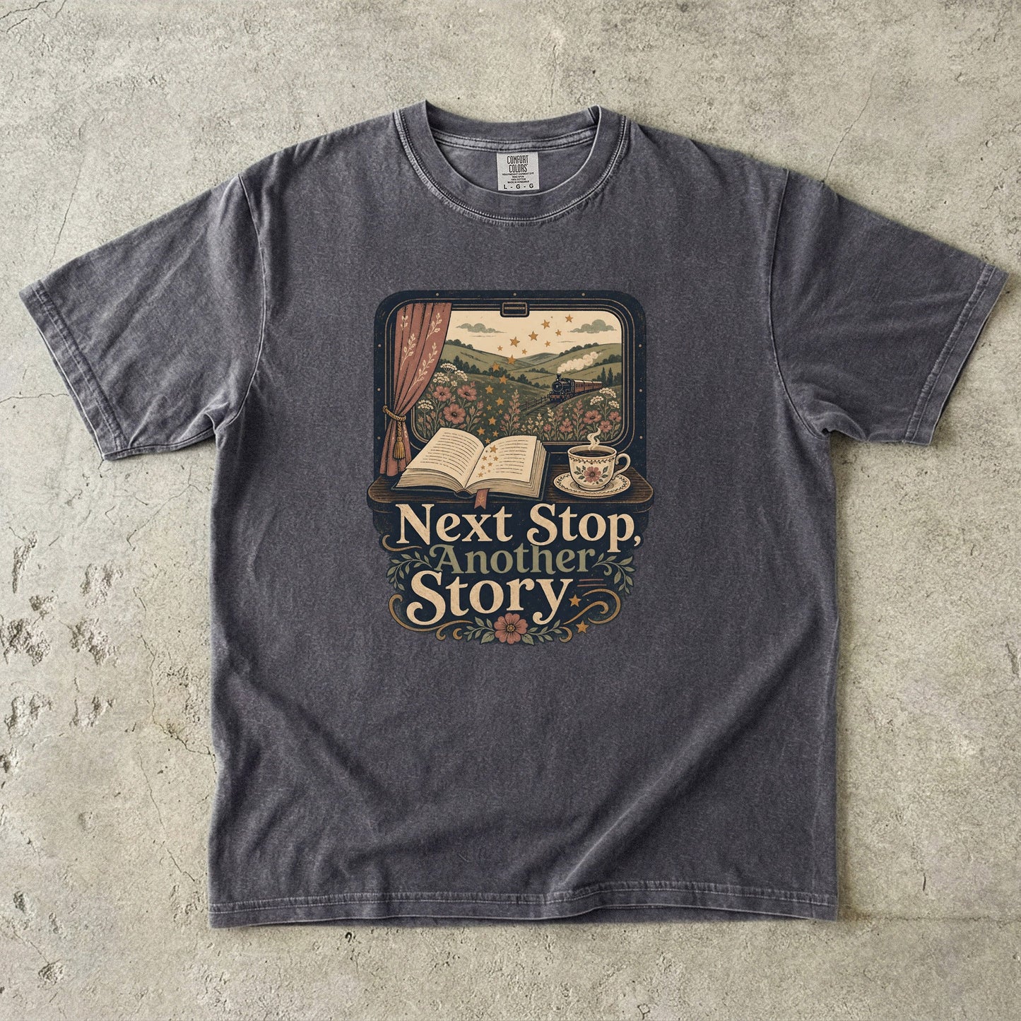Front view of a Pepper Comfort Colors Book Lover Shirt featuring a vintage railway journey with books, tea and countryside views.