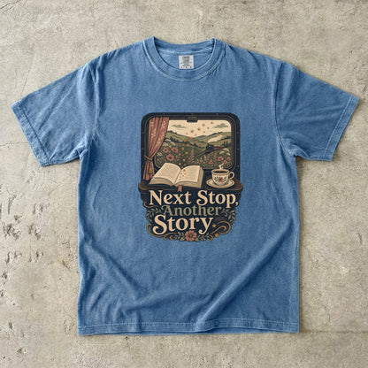 Next Stop, Another Story reading T-shirt in Blue Jean featuring a countryside steam train, open book and floral teacup