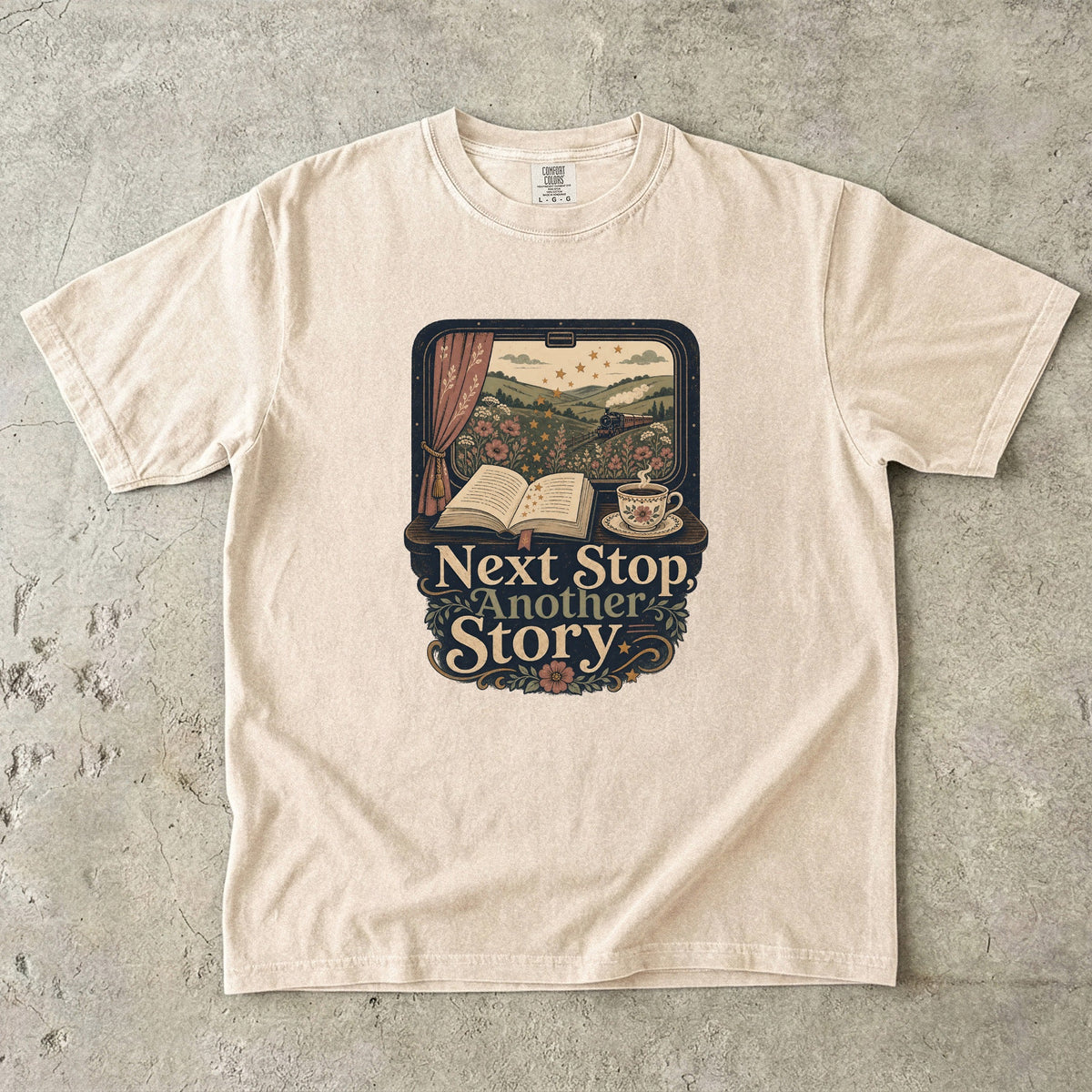 Next Stop, Another Story reading T-shirt in Ivory featuring a countryside steam train, open book and floral teacup