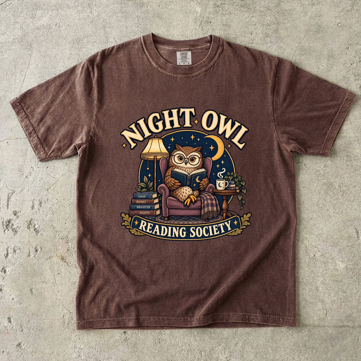 Espresso T-shirt featuring “Night Owl Reading Society” with a spectacled owl reading in an armchair, a lamp, books, mug, crescent moon and stars.