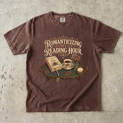 Front view of an Espresso Comfort Colors® book lover T-shirt featuring the Romanticizing My Reading Hour vintage literary design with books, tea, candlelight and romantic floral details.