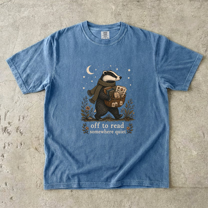 Off to Read Somewhere Quiet badger reading T-shirt in Blue Jean featuring a scarfed badger carrying books and tea